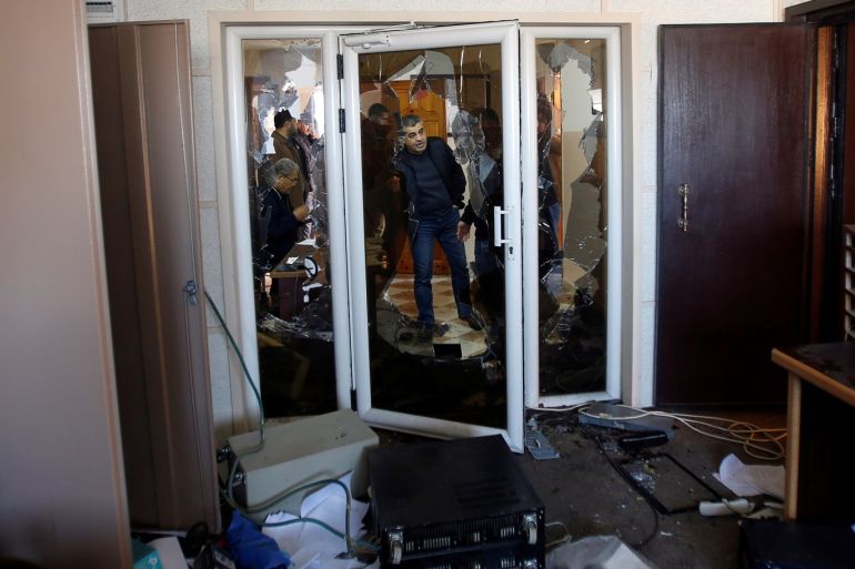 Palestinians inspect the damage inside the office of Palestine TV, in Gaza City January 4, 2019. REUTERS/Ahmed Zakot
