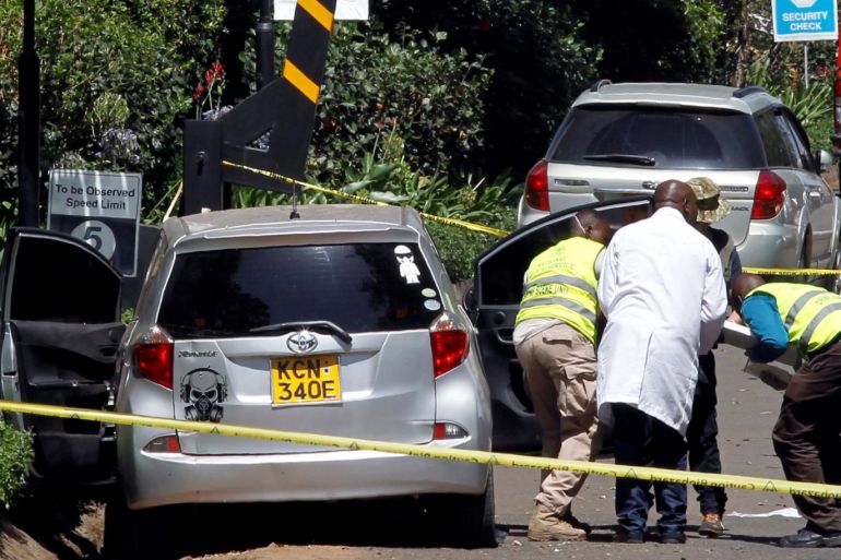Kenyan policemen and explosives experts gather evidence from the car suspected to have been used by the attackers outside the scene where explosions and gunshots were heard at The DusitD2 complex, in Nairobi, Kenya January 17, 2019. REUTERS/Njeri Mwangi