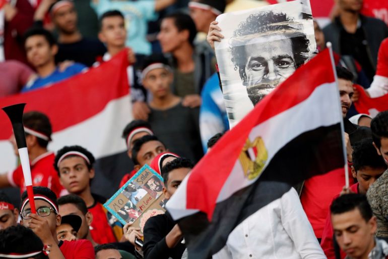 Soccer Football - African Nations Cup Qualifier - Egypt v Tunisia - Borg El Arab Stadium, Alexandria, Egypt - November 16, 2018 Egypt fans with a picture of Mohamed Salah before the match REUTERS/Amr Abdallah Dalsh