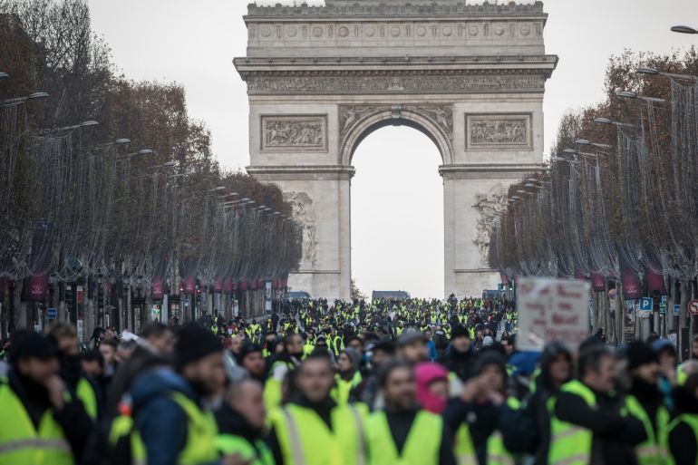 PARIS, FRANCE - DECEMBER 08: Protesters chant slogans as during the 'yellow vests' demonstration on the Champs-Elysées near the Arc de Triomphe on December 8, 2018 in Paris France. ''Yellow Vests' ('Gilet Jaunes' or 'Vestes Jaunes') is a protest movement without political affiliation which was inspired by opposition to a new fuel tax. After a month of protests, which have wrecked parts of Paris and other French cities, there are fears the movement has been infi