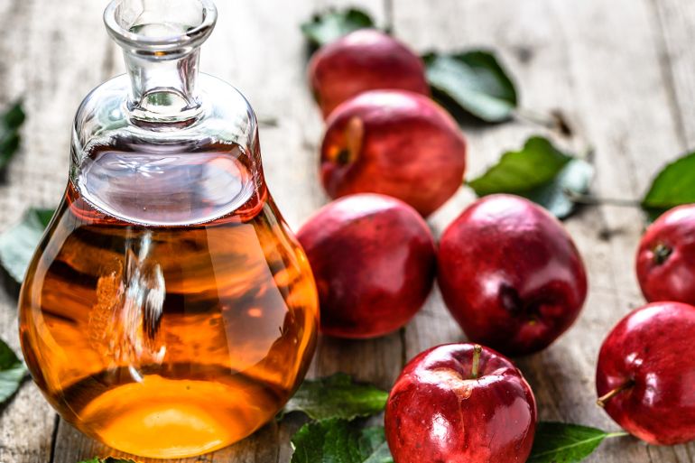 Apple cider vinegar or bottle of alcohol drink from fresh apples, organic food, healthy diet concept