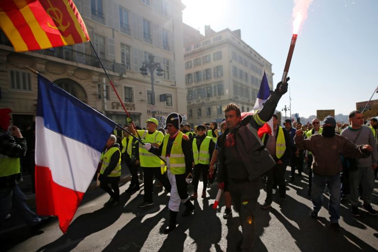 Protesters wearing yellow vests take part in a demonstration of the