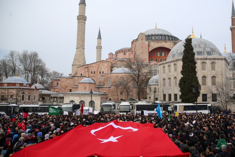 Reactions to twin terror attacks on New Zealand mosques in Turkey- - ISTANBUL, TURKEY - MARCH 16: People stage a demonstration condemning twin terror attacks targeting mosques in Christchurch, New Zealand, on March 16, 2019 in front of Hagia Sophia Museum as they unfurl a Turkish flag in Istanbul, Turkey. At least 49 people were reportedly killed in the terror attacks.