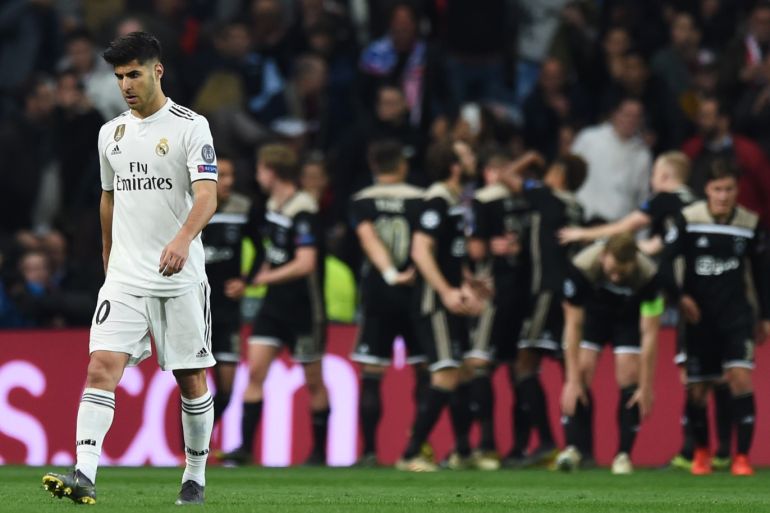 MADRID, SPAIN - MARCH 05: Marco Asensio of Real Madrid reacts as of Ajax players celebrate as Lasse Schone scores his team's fourth goal 1 during the UEFA Champions League Round of 16 Second Leg match between Real Madrid and Ajax at Bernabeu on March 05, 2019 in Madrid, Spain. (Photo by Denis Doyle/Getty Images)