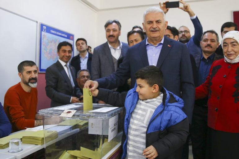 AK Party’s Istanbul mayoral candidate Yildirim cast vote in Turkey's local election- - ISTANBUL, TURKEY - MARCH 31: Justice and Development Party’s Istanbul mayoral candidate Binali Yildirim (C) and his wife Semiha Yildirim (R) cast their ballots with their grandchildren Ali and Elif Koylubay at a polling station during local elections in Istanbul, Turkey on March 31, 2019. Polling in Turkey’s local elections began on Sunday, with 57 million registered voters expected