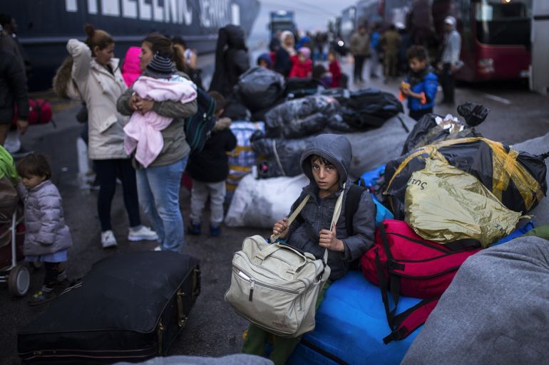 Discharging of Moria refugee camp in Piraeus- - PIRAEUS, GREECE - SEPTEMBER 29: Refugees carry their belongings after the discharge actions were started in the Moria refugee camp of Lesbos, which draws reaction due to the poor living conditions, in Piraeus, Greece on September 29, 2018.