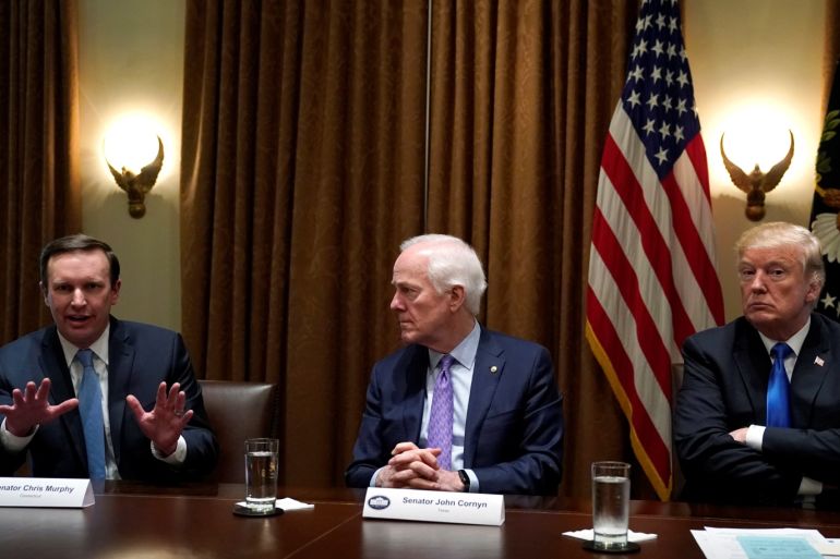 Senator Chris Murphy (D-CT) speaks as Senator John Cornyn (R-TX), C, and U.S. President Donald Trump listen during a bi-partisan meeting with members of Congress to discuss school and community safety in the wake of the Florida school shootings at the White House in Washington, U.S., February 28, 2018. REUTERS/Kevin Lamarque