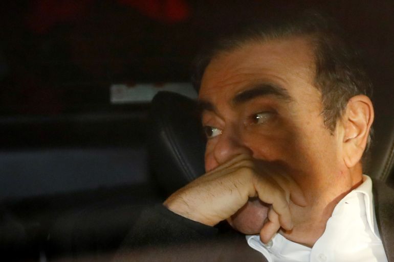 Former Nissan Motor Chairman Carlos Ghosn sits inside a car as he leaves his lawyer's office after being released on bail from Tokyo Detention House, in Tokyo, Japan, March 6, 2019. REUTERS/Issei Kato