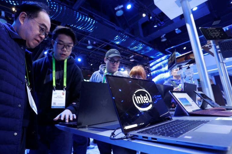 People look over laptops in the Intel booth during the 2019 CES in Las Vegas, Nevada, U.S. January 8, 2019. REUTERS/Steve Marcus