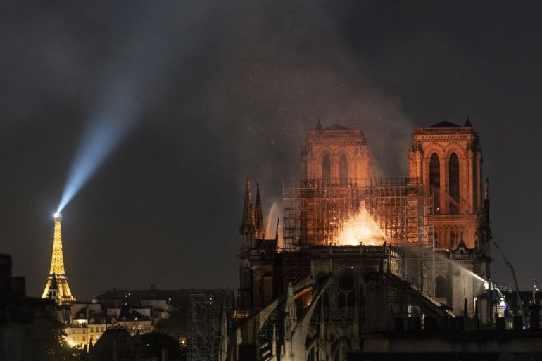 PARIS, FRANCE - APRIL 15: (EDITOR'S NOTE: Re-transmission with alternate crop) Flames and smoke are seen billowing from the roof at Notre-Dame Cathedral on April 15, 2019 in Paris, France. A fire broke out on Monday afternoon and quickly spread across the building, collapsing the spire. The cause is yet unknown but officials said it was possibly linked to ongoing renovation work. (Photo by Veronique de Viguerie/Getty Images)