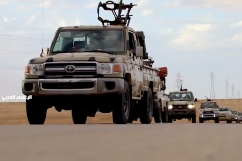 Pickup trucks with mounted weapons drive on a road in Libya, April 4, 2019, in this still image taken from video. Reuters TV via REUTERS