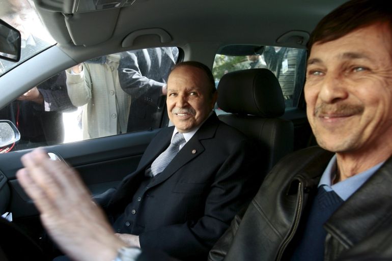 Algeria's President Abdelaziz Bouteflika smiles as he arrives with his brother Said at his campaign's communications department during a surprise visit in Algiers, Algeria April 10, 2009. REUTERS/Zohra Bensemra