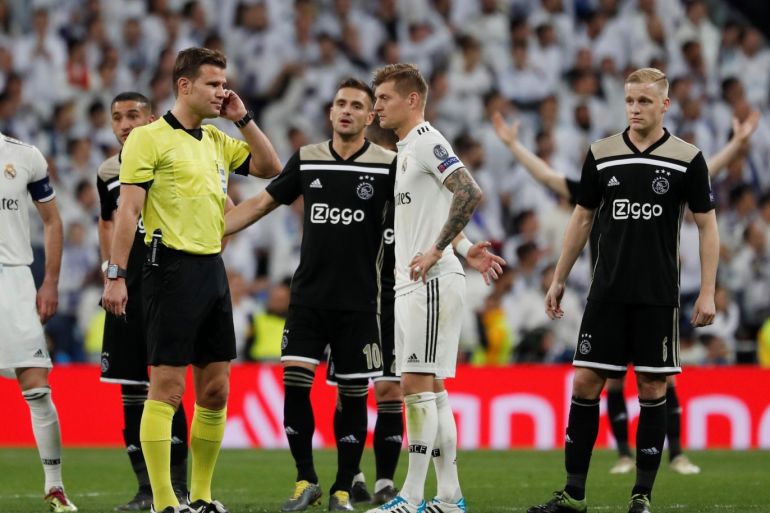 Soccer Football - Champions League - Round of 16 Second Leg - Real Madrid v Ajax Amsterdam - Santiago Bernabeu, Madrid, Spain - March 5, 2019 Referee Felix Brych consults VAR as Ajax's Dusan Tadic reacts after scoring their third goal REUTERS/Susana Vera