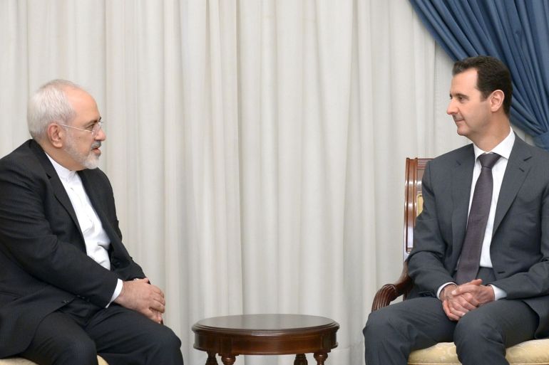 Syria's President Bashar al-Assad (R) meets with Iranian Foreign Minister Mohammad Javad Zarif in Damascus, Syria, in this handout photograph released by Syria's national news agency SANA on August 12, 2015. REUTERS/SANA/Handout via Reuters ATTENTION EDITORS - THIS PICTURE WAS PROVIDED BY A THIRD PARTY. REUTERS IS UNABLE TO INDEPENDENTLY VERIFY THE AUTHENTICITY, CONTENT, LOCATION OR DATE OF THIS IMAGE. FOR EDITORIAL USE ONLY. NOT FOR SALE FOR MARKETING OR ADVERTISING