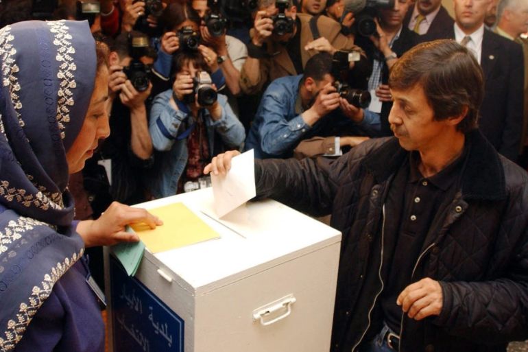 epa07547545 (FILE) - A local Algerian, later identified as Said Bouteflika, is flanked by intense media presence as he casts his vote in the Algerian presidential elections, at a polling station in Algiers, Algeria, 08 April 2004 (reissued 04 May 2019). According to reports, Algerian police on 04 May 2019 arrested Said Bouteflika, the youngest brother of Algerian former president Abdelaziz Bouteflika. His arrest was one of the major demands of the protesters since 22 February as he was seen as the de facto leader when serving as advisor to his brother. EPA-EFE/MOHAMED MESSARA