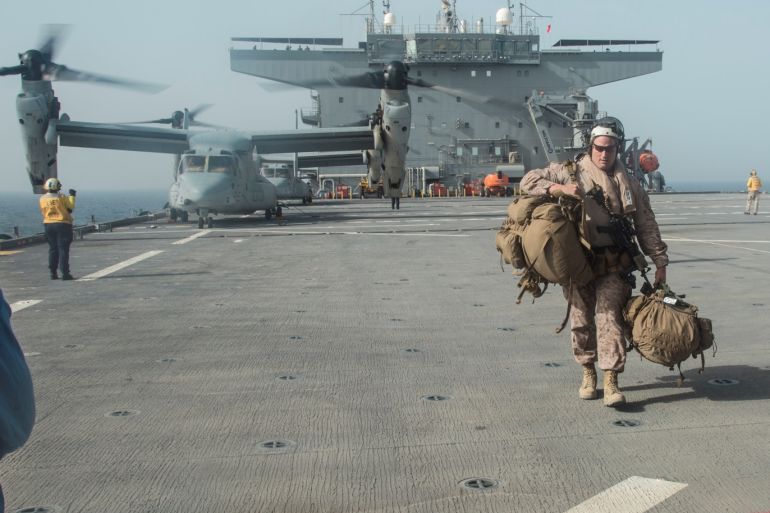U.S. Marine Corps Gunnery Sgt. David Arendt carries his gear across the flight deck of the USS Lewis B. Puller upon embarkation in the Arabian Gulf, May 11, 2019 . Picture taken on May 11, 2019. Courtesy Desiree King/U.S. Marine Corps/Handout via REUTERS ATTENTION EDITORS - THIS IMAGE HAS BEEN SUPPLIED BY A THIRD PARTY.