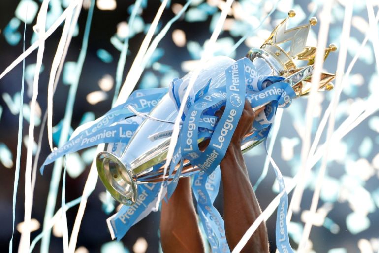 Soccer Football - Premier League - Brighton & Hove Albion v Manchester City - The American Express Community Stadium, Brighton, Britain - May 12, 2019 General view of the trophy being lifted by Manchester City's Vincent Kompany as he celebrates winning the Premier League Action Images via Reuters/John Sibley EDITORIAL USE ONLY. No use with unauthorized audio, video, data, fixture lists, club/league logos or