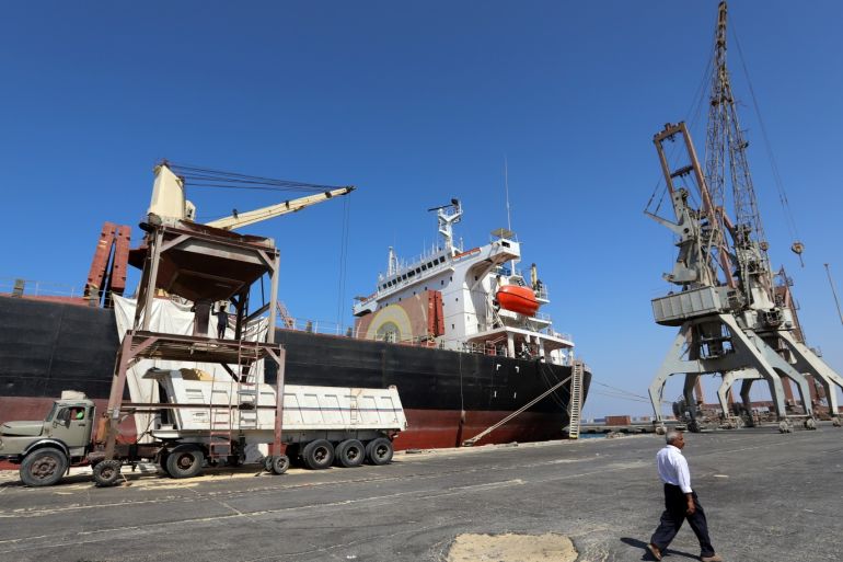 A worker walks past a ship unloading a grain shipment at the Red Sea port of Hodeidah, Yemen January 5, 2019. Picture taken January 5, 2019. REUTERS/Abduljabbar Zeyad