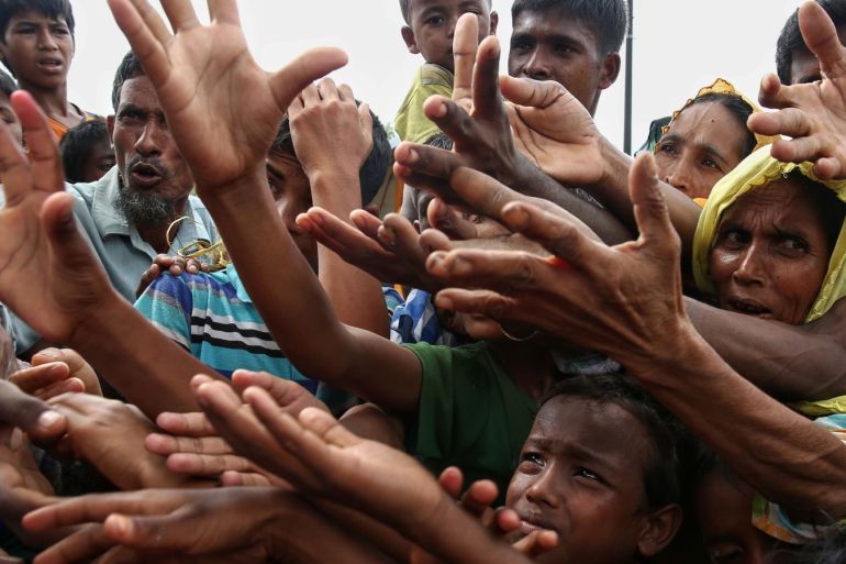 This August 30, 2017 photo shows Rohingya refugees reaching for food aid at Kutupalong refugee camp in Ukhiya near the Bangladesh-Myanmar border.The International Organization for Migration said August 30 that at least 18,500 Rohingya had crossed into Bangladesh since fighting erupted in Myanmar's neighbouring Rakhine state six days earlier. / AFP PHOTO / STR        (Photo credit should read STR/AFP/Getty Images)
