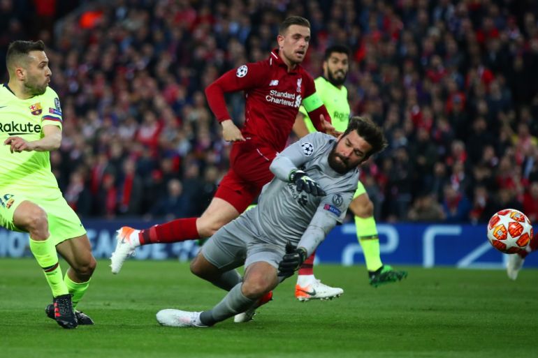 LIVERPOOL, ENGLAND - MAY 07: Jordi Alba of Barcelona is foiled by Alisson of Liverpool during the UEFA Champions League Semi Final second leg match between Liverpool and Barcelona at Anfield on May 07, 2019 in Liverpool, England. (Photo by Clive Brunskill/Getty Images)