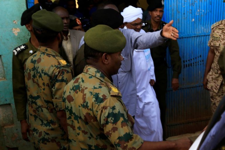 Sudan's former President Omar al-Bashir is escorted as he walks out from the National Prison in Khartoum, Sudan June 16, 2019. REUTERS/Mohamed Nureldin Abdallah