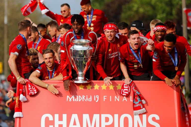 Soccer Football - Champions League - Liverpool victory parade - Liverpool, Britain - June 2, 2019 Liverpool's Jordan Henderson, Divock Origi, Alberto Moreno, Andrew Robertson, Trent Alexander-Arnold, Alex Oxlade-Chamberlain and team mates with the trophy during the parade REUTERS/Phil Noble