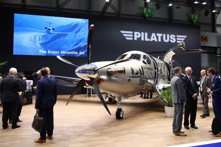 Visitors talk on the Pilatus stand during the European Business Aviation Convention & Exhibition (EBACE) at Cointrin Airport in Geneva, Switzerland May 21, 2019. REUTERS/Denis Balibouse