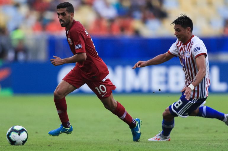 RIO DE JANEIRO, BRAZIL - JUNE 16: Hassan Al-Haydos of Qatar and Richard Ortiz of Paraguay compete for the ball during the Copa America Brazil 2019 group B match between Paraguay and Qatar at Maracana Stadium on June 16, 2019 in Rio de Janeiro, Brazil. (Photo by Buda Mendes/Getty Images)