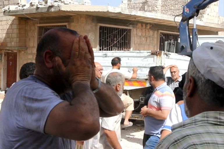 Airstrikes hit Syria's Idlib- - IDLIB, SYRIA - MAY 30 : A man cries as civil defence crews and locals conduct search and rescue works at a debris of a building after Assad Regime's warplanes carried out airstrike over Maarat al-Numaan district of Idlib de-escalation zone in Syria on May 30, 2019. 5 people were reported killed on the airstrike.