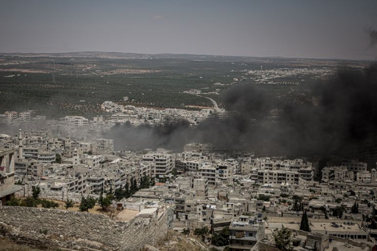 Regime attacks kill 6 in Syria’s de-escalation zone- - IDLIB, SYRIA - JULY 28: Smoke rises after Assad Regime warplanes carried out airstrikes on the town of Arihah in Idlib province, Syria on July 28, 2019. At least six civilians were killed and 18 others injured in regime attacks in de-escalation zone in northwestern Syria.