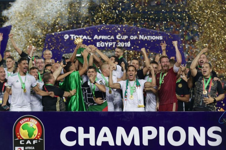 Algeria wins 2019 Africa Cup of Nations- - CAIRO, EGYPT - JULY 19: Algerian team celebrate championship with trophy after the 2019 Africa Cup of Nations final match between Senegal and Algeria at the Cairo Stadium in Cairo, Egypt on July 19, 2019. Algeria won their first Africa Cup of Nations (AFCON) title in 29 years, beating Senegal 1-0 late Friday in Egypt.