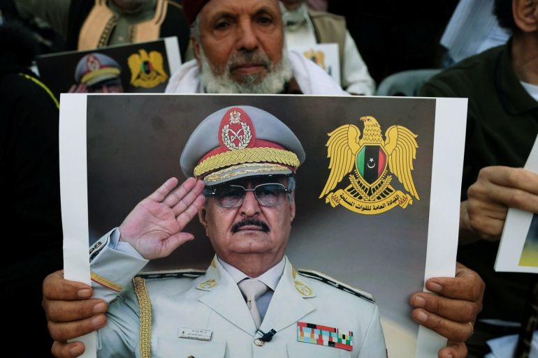 A Libyan man carries a picture of Khalifa Haftar during a demonstration to support Libyan National Army offensive against Tripoli, in Benghazi, Libya April 12, 2019. REUTERS/Esam Omran Al-Fetori