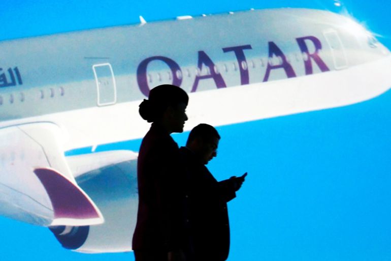 People are silhouetted in front of a screen as Airbus delivers the first A350-1000, the largest member of the new Airbus wide-body family and the largest twin-engined jet built in Europe, to Qatar Airways, in Blagnac near Toulouse, France, February 20, 2018. REUTERS/Regis Duvignau