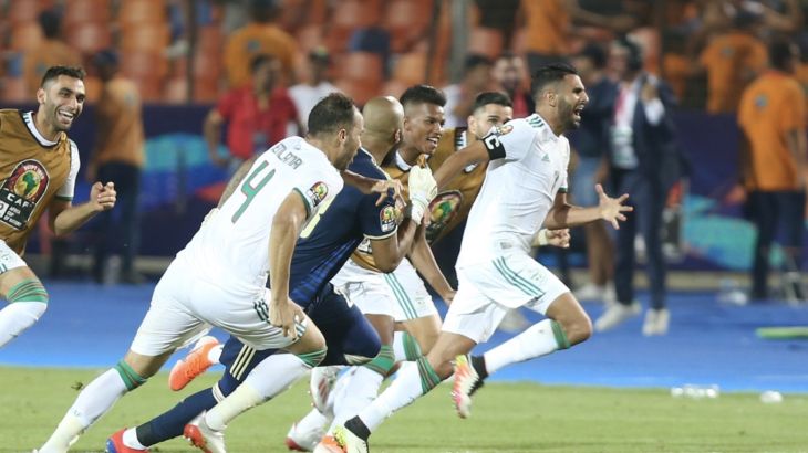 Algeria vs Nigeria: 2019 Africa Cup of Nations- - CAIRO, EGYPT - JULY 14: Riyad Mahrez (R) of Algeria celebrates after scoring a goal with his team mates during the 2019 Africa Cup of Nations semifinal football match between Algeria and Nigeria at the Cairo Stadium in Cairo, Egypt on July 14, 2019. Algeria got to the final by besting Nigeria 2-1 in the semifinal match.