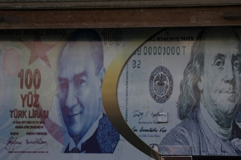 Posters of U.S. dollar and Turkish lira are seen on a currency exchange shop in the city of Azaz, Syria August 18, 2018. Picture taken August 18, 2018. REUTERS/ Khalil Ashawi