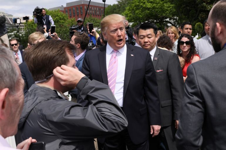 U.S. President Donald Trump talks with aides and U.S. Secret Service agents as he attends the 2019 White House Easter Egg Roll in Washington, U.S., April 22, 2019. REUTERS/Jonathan Ernst
