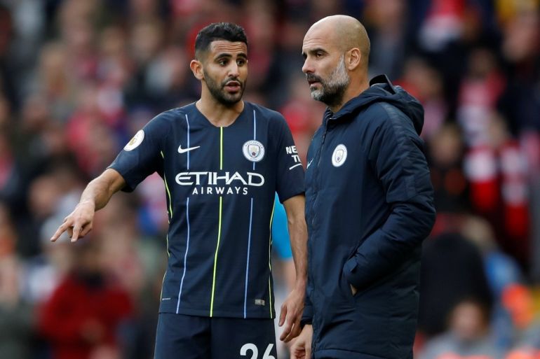 Soccer Football - Premier League - Liverpool v Manchester City - Anfield, Liverpool, Britain - October 7, 2018 Manchester City's Riyad Mahrez with manager Pep Guardiola during the match Action Images via Reuters/Carl Recine EDITORIAL USE ONLY. No use with unauthorized audio, video, data, fixture lists, club/league logos or