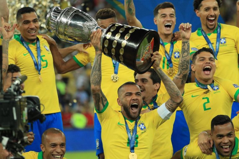 RIO DE JANEIRO, BRAZIL - JULY 07: Dani Alves of Brazil celebrates with the trophy and his teammates after winning the Copa America Brazil 2019 Final match between Brazil and Peru at Maracana Stadium on July 07, 2019 in Rio de Janeiro, Brazil. (Photo by Buda Mendes/Getty Images)