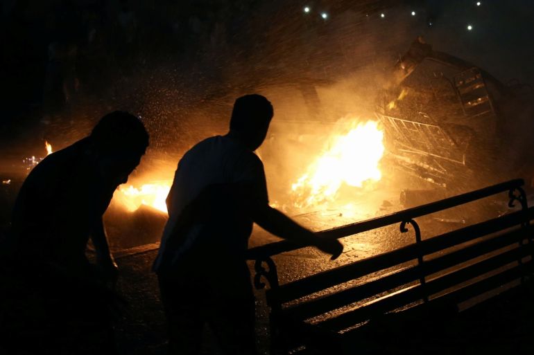 People extinguish a fire from a blast outside the National Cancer Institute, Cairo, Egypt August 4, 2019. REUTERS/Shokry Hussien
