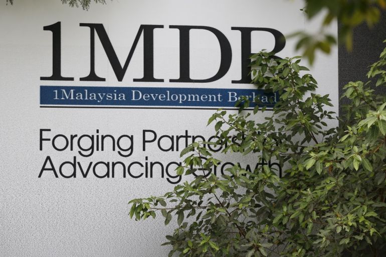 Foliage partly covers a 1 Malaysia Development Berhad (1MDB) billboard at the funds flagship Tun Razak Exchange development in Kuala Lumpur, Malaysia, July 3, 2015. Malaysian Prime Minister Najib Razak slammed a report that said close to $700 million was wired to his personal account from banks, government agencies and companies linked to the debt-laden state fund 1MDB, claiming this was a