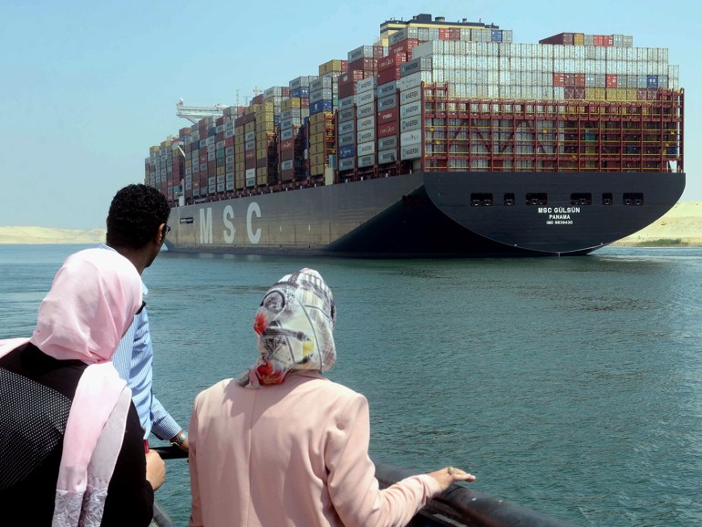 epa07764051 People watch the MSC Gulsun, the world's largest container ship by carrying capacity, as it sails through the Suez Canal in Ismailia, Egypt, 09 August 2019. The 400-metre long container ship MSC Gulsun which is capable of carrying up to 23,756 twenty-foot equivalent units (TEU) a time, was delivered to Mediterranean Shipping Company (MSC) in July and embarked on the first journey from Xingang to northern Europe. EPA-EFE/STRINGER