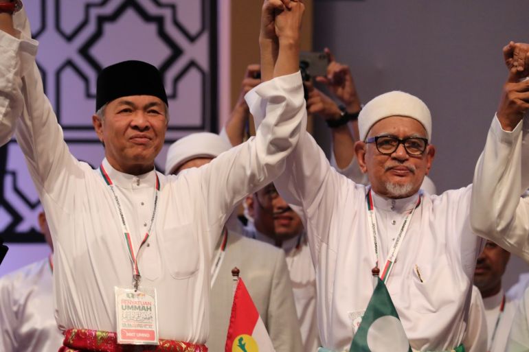 United Malays National Organization (UMNO) President Ahmad Zahid Hamidi (L) and Pan-Malaysian Islamic Party (PAS) President Hadi Awang hold hands during Ummah Unity Gathering in Kuala Lumpur, Malaysia, September 14, 2019. REUTERS/Lim Huey Teng