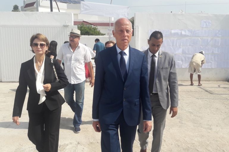 Presidential Election in Tunisia- - ARYANAH, TUNISIA - SEPTEMBER 15 : Presidential candidate Kais Saied (2nd R) arrives to cast his ballot for presidential election at a polling station in Aryanah, Tunisia on September 15, 2019.