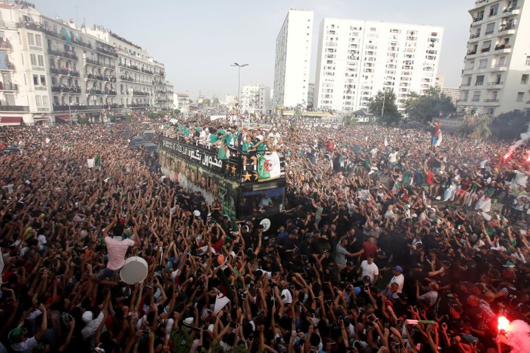 Soccer Football - Algeria celebrate winning the Africa Cup of Nations 2019 in Algiers - Algiers, Algeria - July 20, 2019 Fans celebrate as the Algeria team bus travels through Algiers REUTERS/Ramzi Boudina TPX IMAGES OF THE DAY
