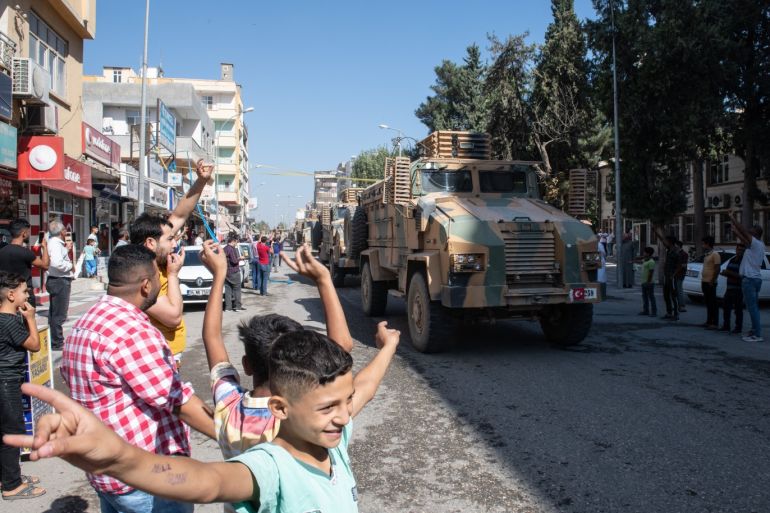 AKCAKALE, TURKEY - OCTOBER 10: Turkish armoured vehicles escort members of the Turkish-backed Free Syrian Army, a militant group active in parts of northwest Syria, as they enter Syria on October 10, 2019 in Akcakale, Turkey. The military action is part of a campaign to extend Turkish control of more of northern Syria, a large swath of which is currently held by Syrian Kurds, whom Turkey regards as a threat. U.S. President Donald Trump granted tacit American approval to