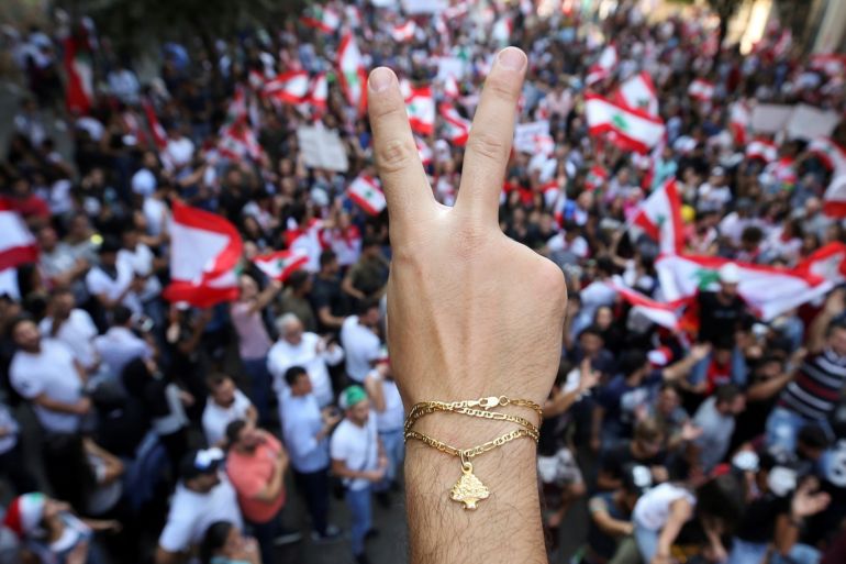 A demonstrator flashes a V sign during an anti-government protest in downtown Beirut, Lebanon October 21, 2019. REUTERS/Ali Hashisho TPX IMAGES OF THE DAY