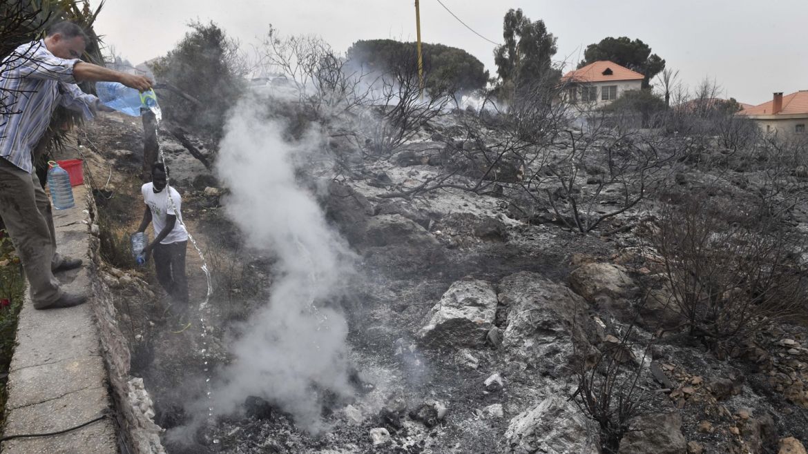 Wildfire in Lebanon- - BEIRUT, LEBANON - OCTOBER 15: People extinguish fire after fire took out forests in the mountainous area that flank Damour river near the village of Meshref in Lebanon's Shouf mountains, southeast of the capital Beirut, Lebanon on October 15, 2019. Flames devoured large swaths of land in several Lebanese and Syrian regions. The outbreak coincided with high temperatures and strong winds, according to the official media in both countries.