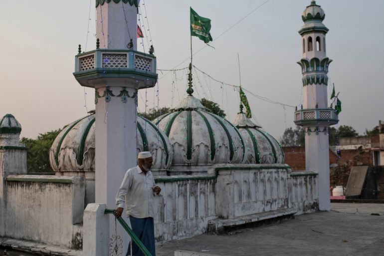 A Muslim man walks down from the roof of a mosque after Supreme Court's verdict on a disputed religious site, in Ayodhya, India, November 10, 2019. REUTERS/Danish Siddiqui