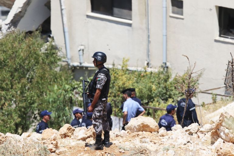 AL-SALT, JORDAN- AUGUST 12: Jordanian emergency services and security forces attend the scene of a damaged building during a police raid on a house sheltering terrorists suspected of being behind a bomb attack on a police van on Friday night, on Sunday August 12, 2018, in Al Salt, Jordan. Four police officers were killed and twenty four including civilians residents of the building were injured as three militiants were killed and five arrested. (Photo by Getty Images)