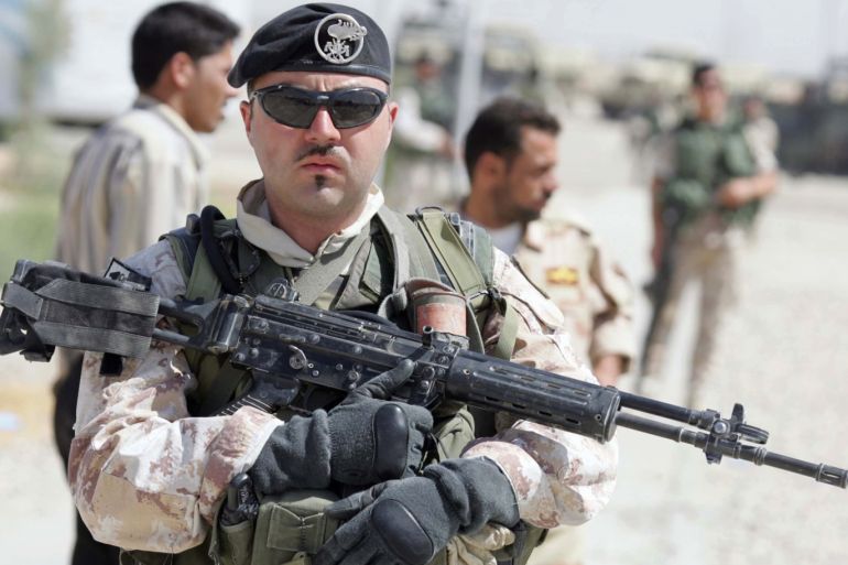 An Italian soldier holds a weapon while on guard during the hand over ceremony of the control of Dhi Qar province from the Italian troops to Iraqi soldiers in the southern city of Nassiriya, September 21, 2006. The 1,600 Italians, under British command in the southern sector, will all be home within eight weeks after turning over responsibility for security in Dhi Qar province to Iraqis, British military spokesman Major Charlie Burbridge said. REUTERS/Atef Hassan (IRAQ)